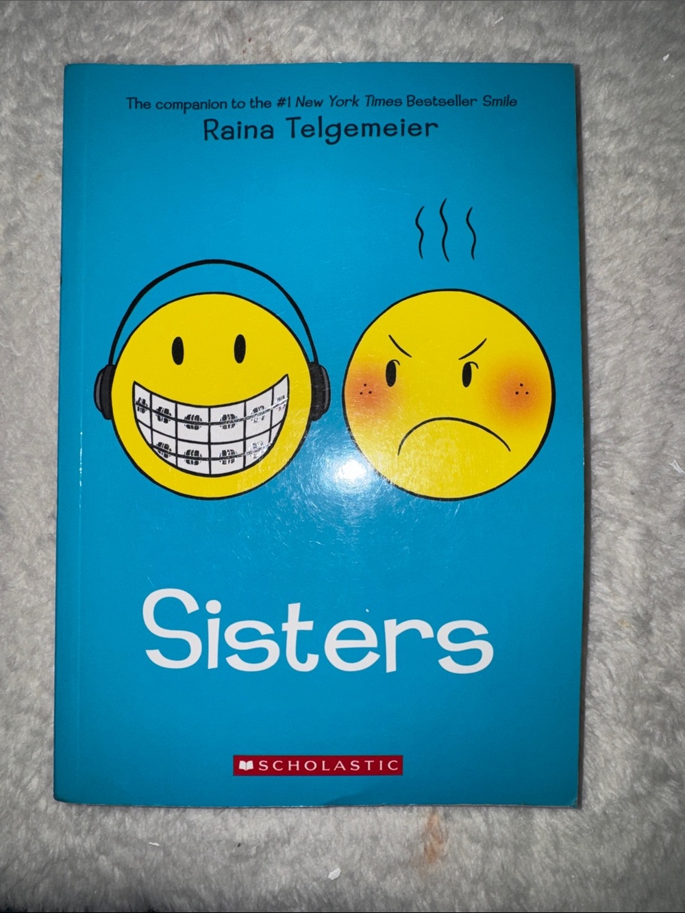 Scholastic Blue Cover Graphic Novel with Yellow Emoji Faces